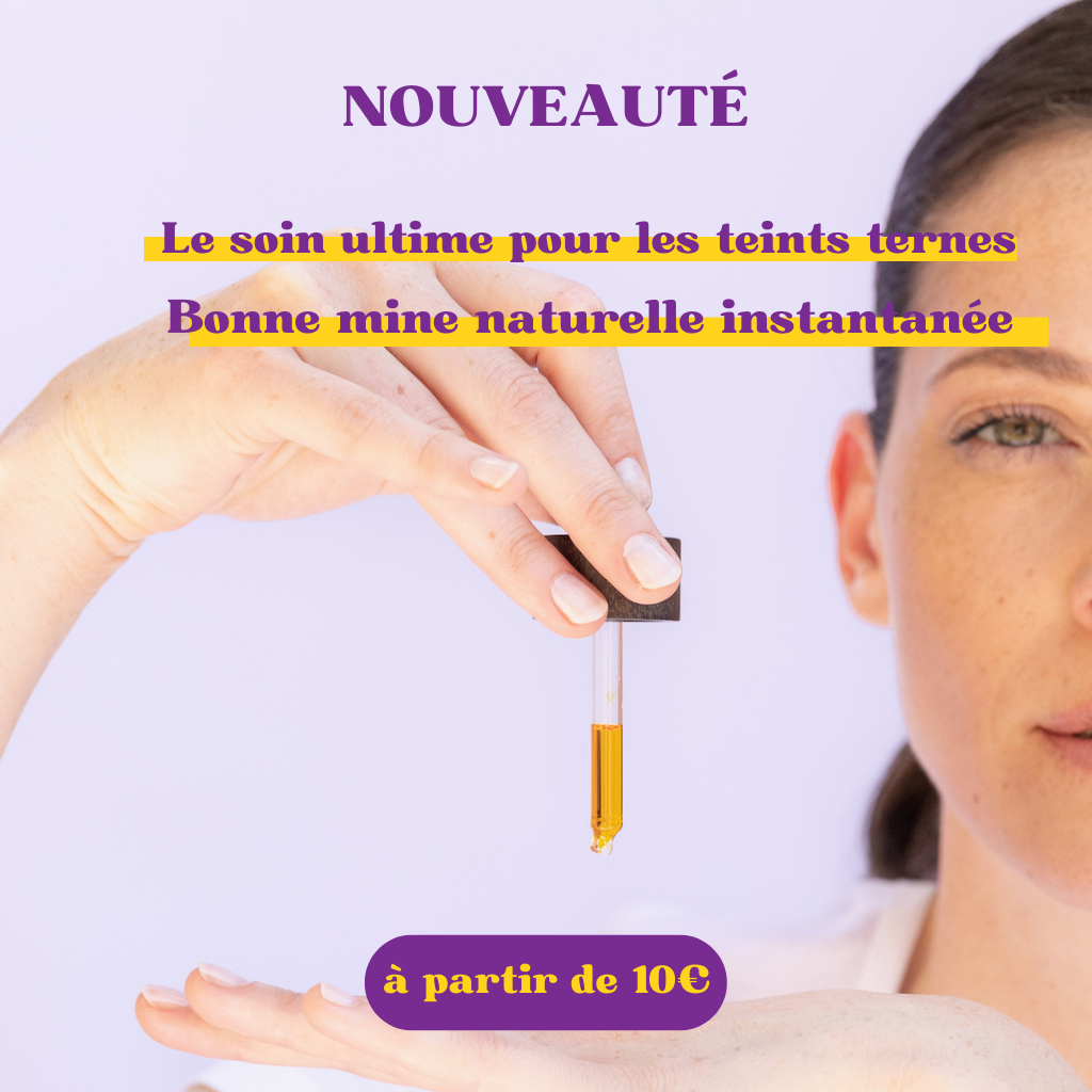 Une main tient une pipette dans laquelle se trouve une substance orange qui pointe vers son autre main. La moitié du visage de la femme est coupé. Elle a un jolie teint. Sur l'image il est écrit nouveauté, le soin ultime pour les teints ternes. Bonne mine naturelle instantannée, à partir de 10 euors.